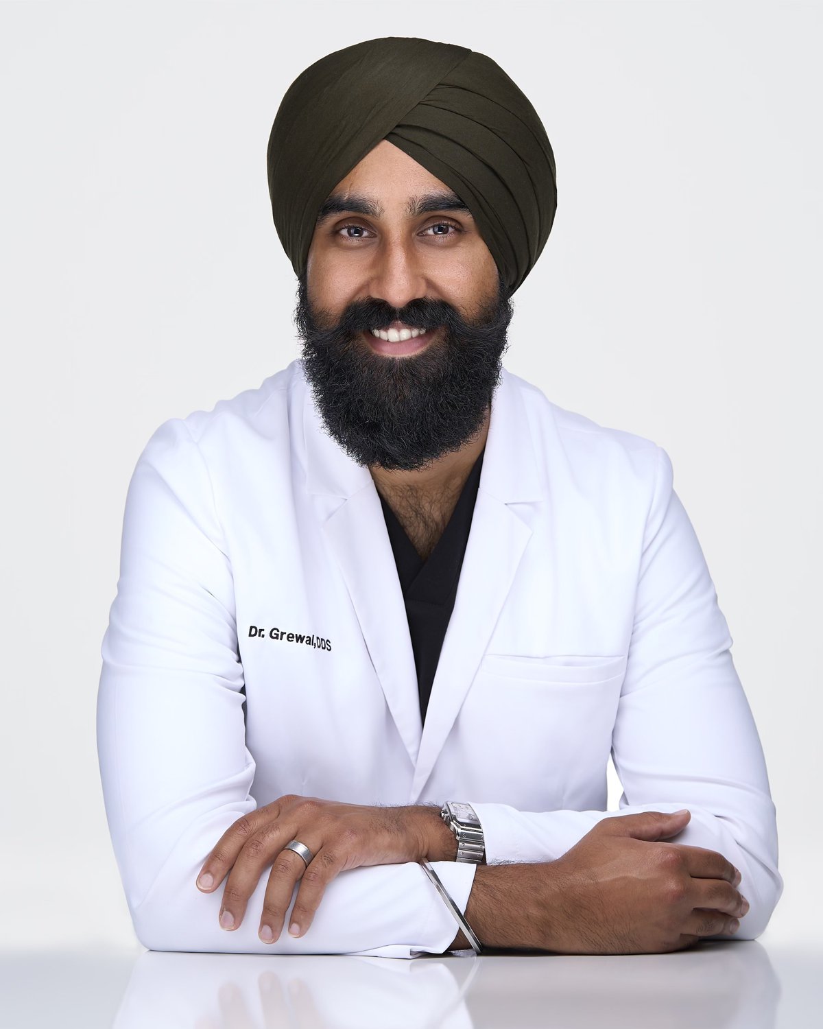 Dr. Karan Grewal, DDS, in a white coat